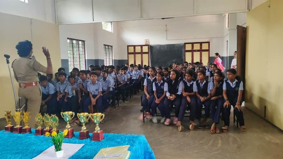 School assembly with students seated before the stage